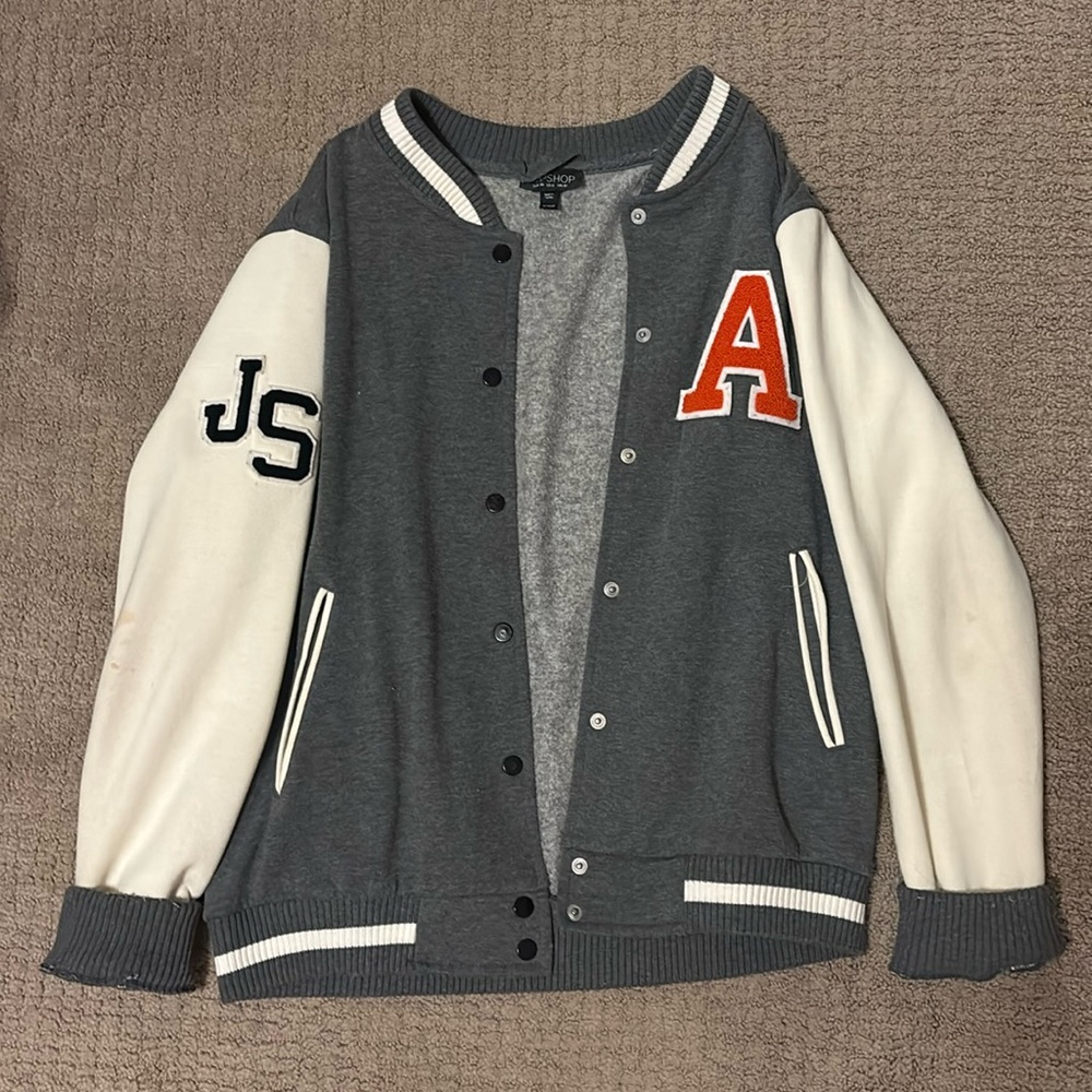 A letterman jacket that has “character”. I’m not sure what the A & JS stand for.